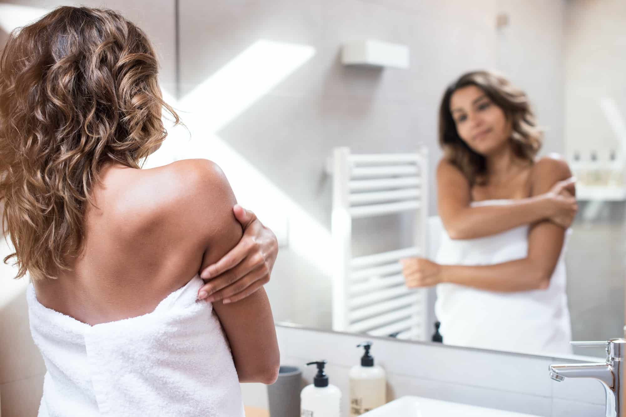 Woman applying body lotion.jpg