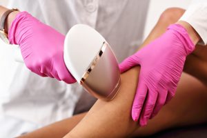 Adult woman having laser hair removal in professional beauty salon